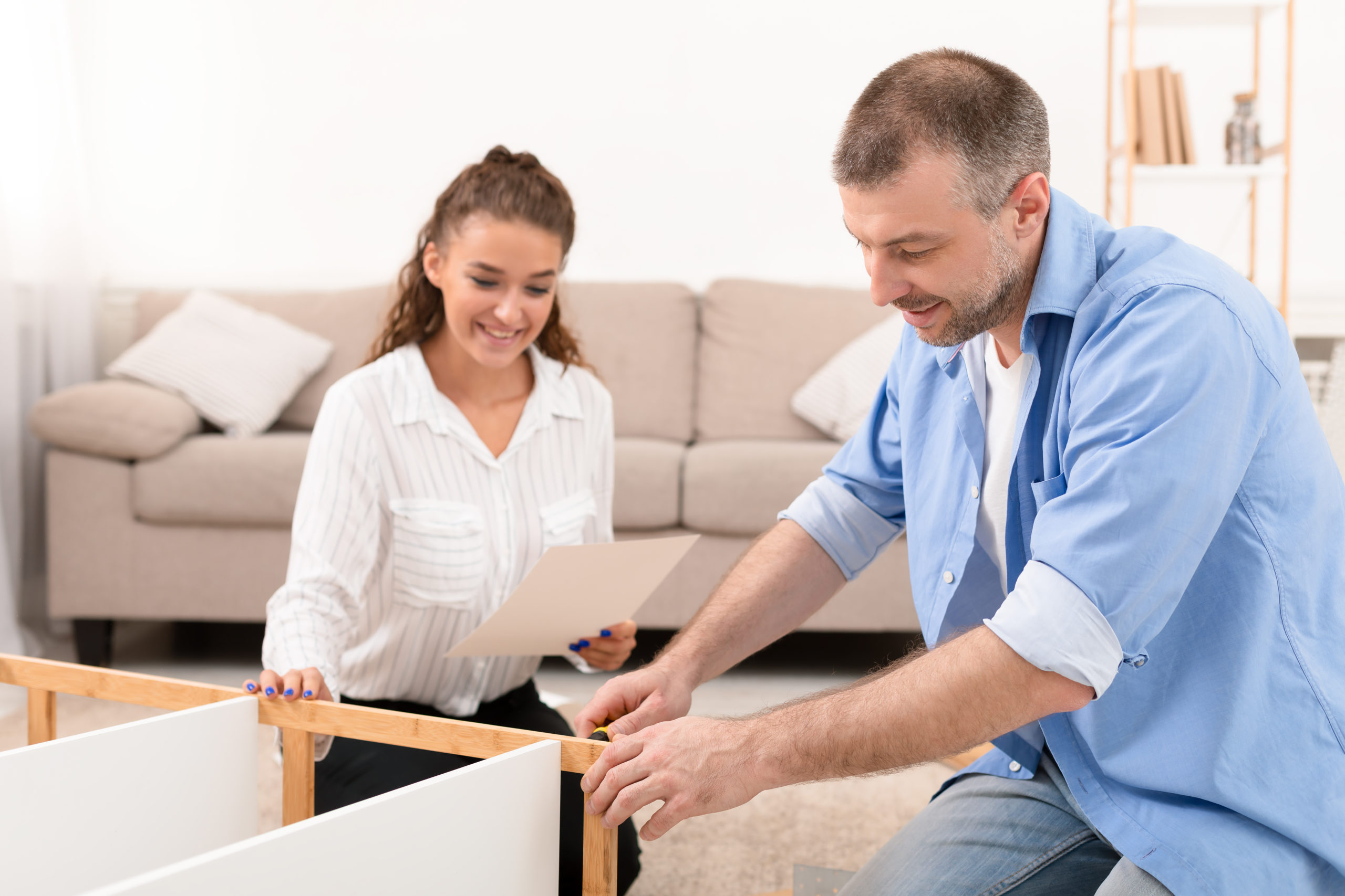 couple installing furniture after approved home improvement loan