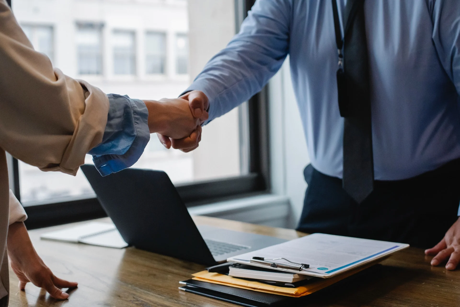 handshake-between-2-people.webp handshake between 2 people